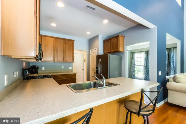a kitchen with a table chairs and refrigerator