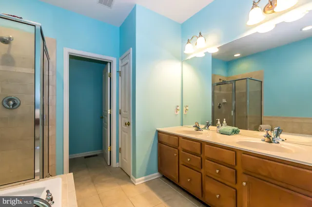 a bathroom with a double vanity sink mirror and double