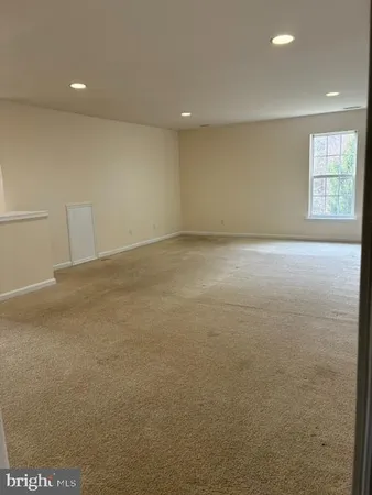 a view of an empty room with windows