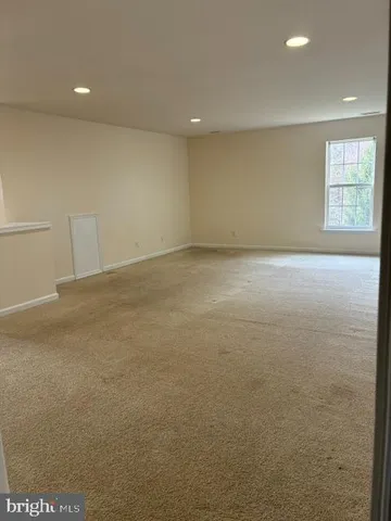 a view of an empty room with windows
