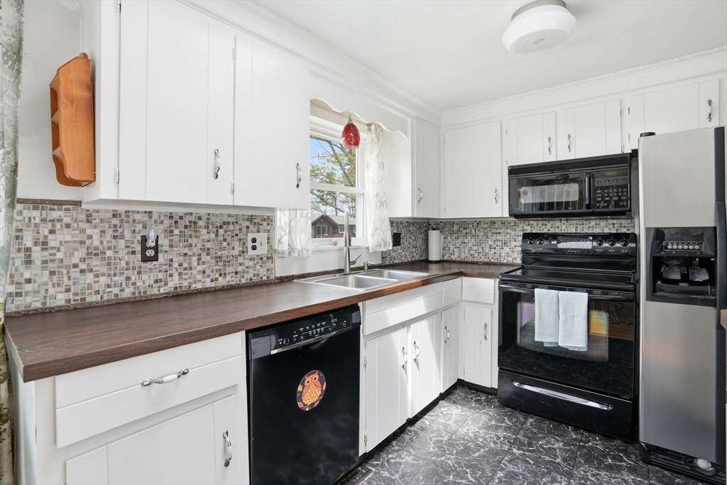 94 Edgewater Drive Wareham, MA 02571 - Photo 18 of 37 a kitchen with stainless steel appliances granite countertop a stove a sink and a microwave