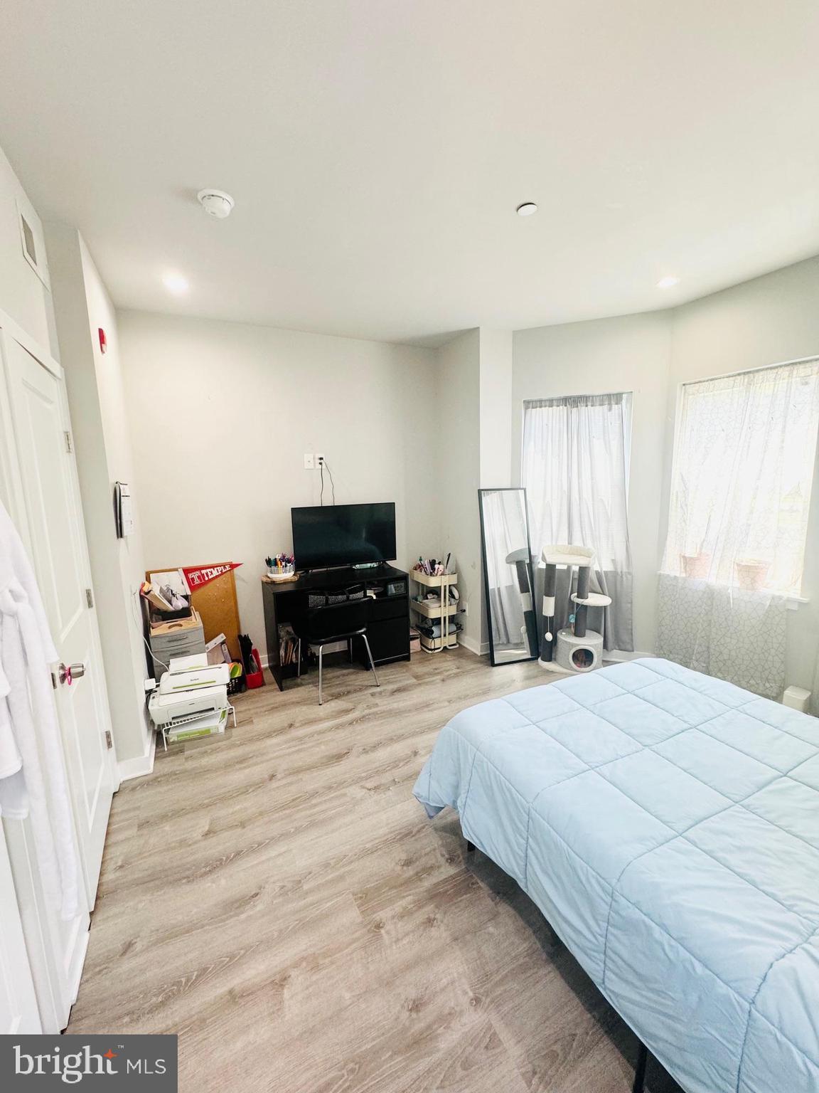 2327 Wharton Street, Unit 2 Philadelphia, PA 19146 - Photo 16 of 19 a bedroom with a bed and a chair