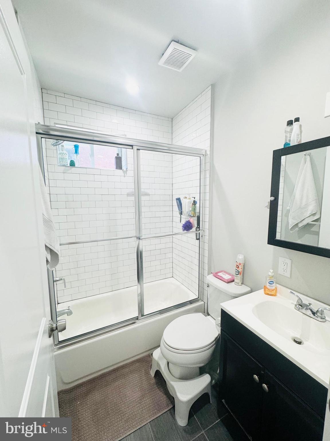 2327 Wharton Street, Unit 2 Philadelphia, PA 19146 - Photo 19 of 19 a bathroom with a toilet sink vanity tub and shower