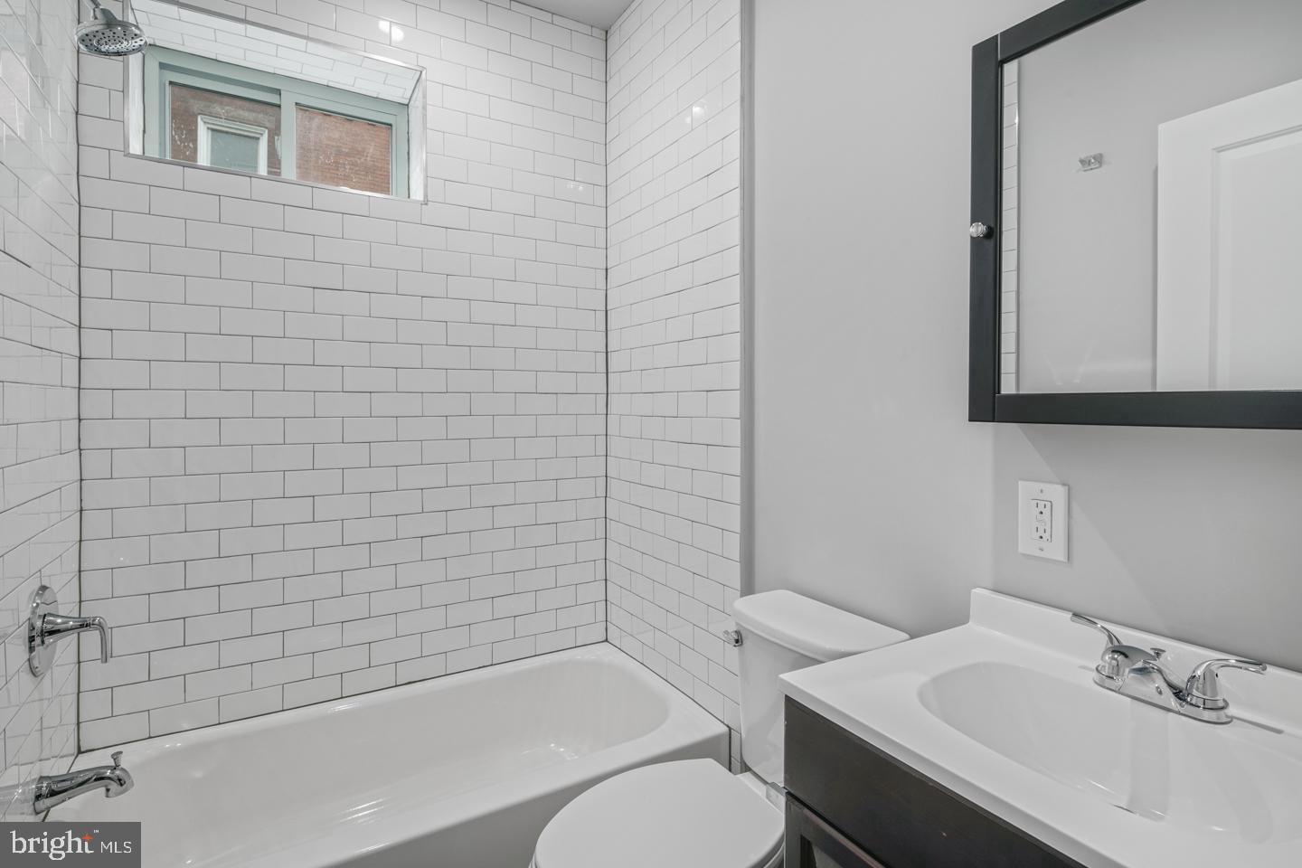 2327 Wharton Street, Unit 2 Philadelphia, PA 19146 - Photo 3 of 19 a bathroom with a sink a toilet and shower