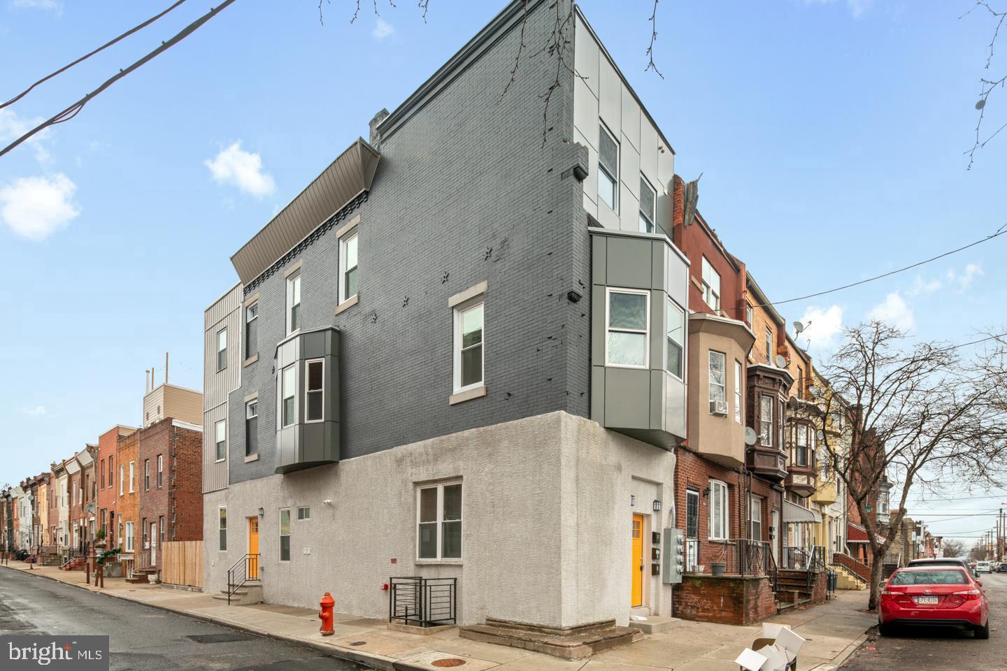 2327 Wharton Street, Unit 2 Philadelphia, PA 19146 - Photo 6 of 19 a city street lined with buildings and cars