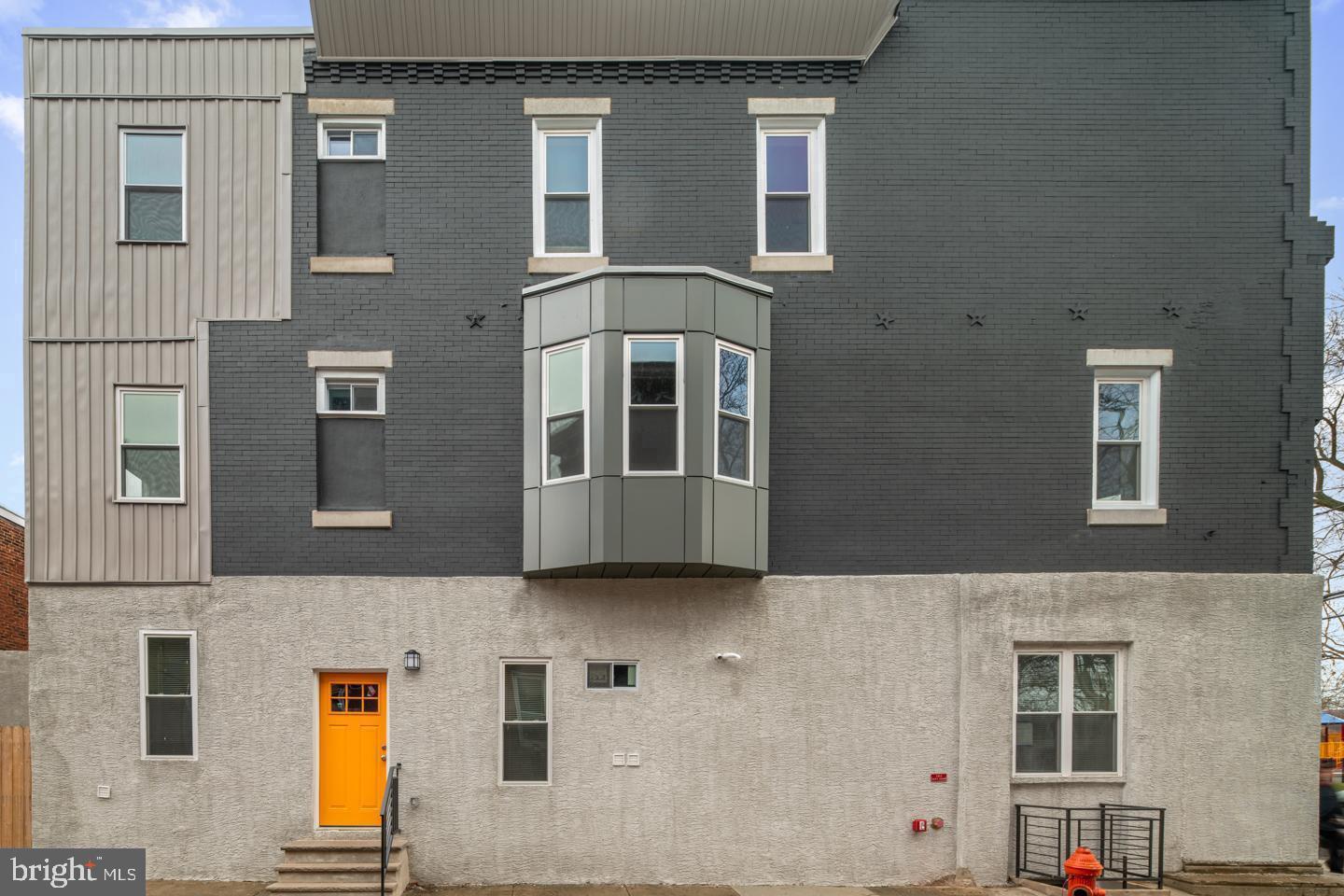 2327 Wharton Street, Unit 2 Philadelphia, PA 19146 - Photo 8 of 19 a front view of a building with large windows