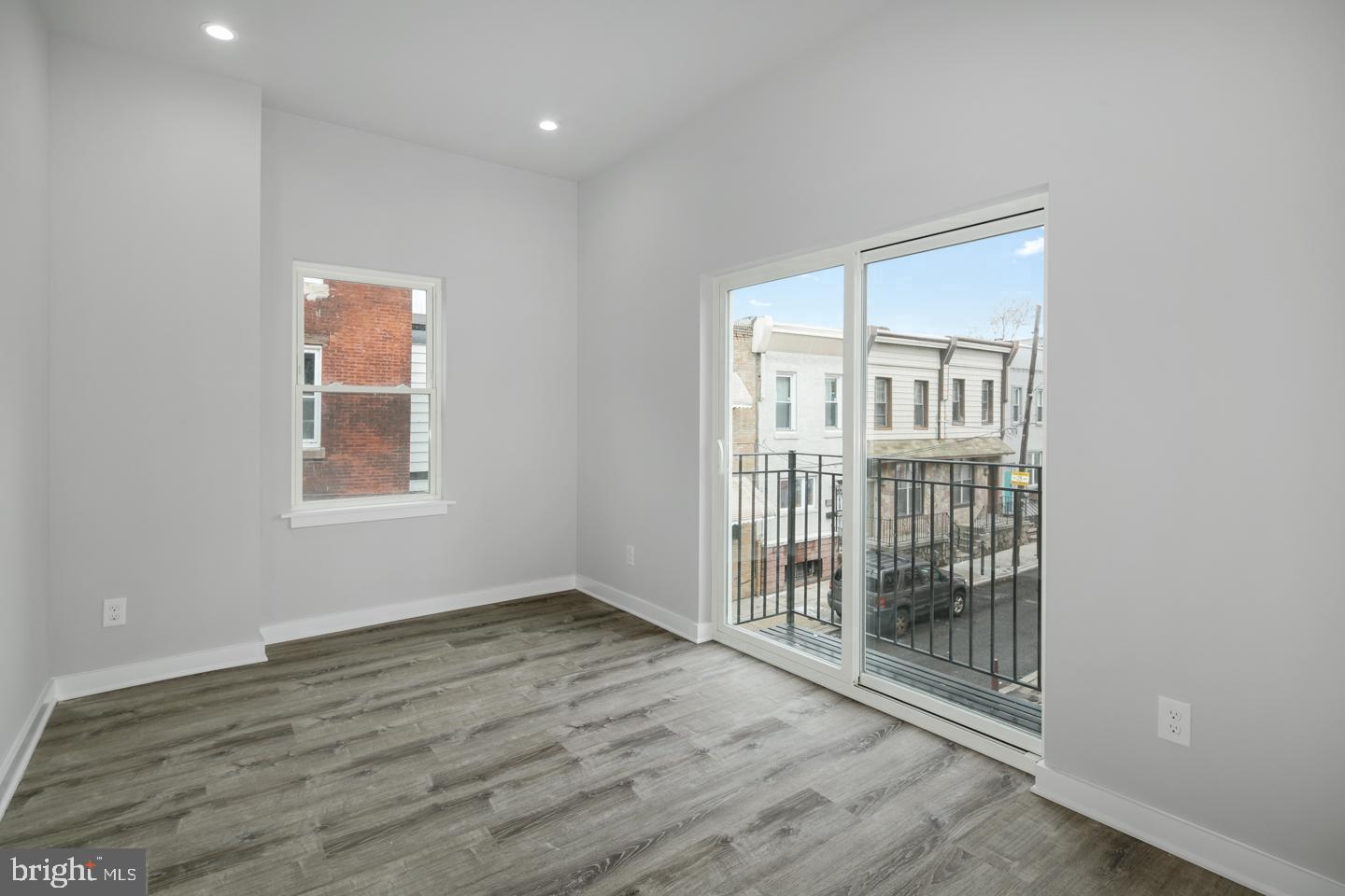 2327 Wharton Street, Unit 2 Philadelphia, PA 19146 - Photo 9 of 19 an empty room with wooden floor and windows
