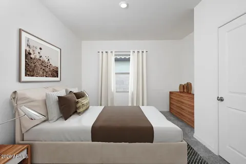a bedroom with a bed and a couch