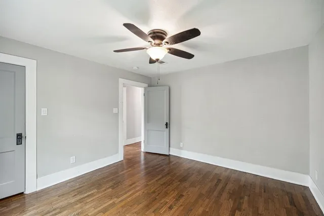 a view of an empty room with wooden floor