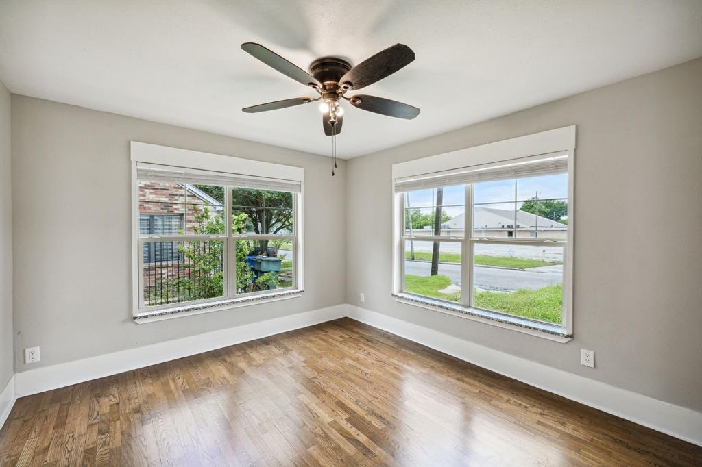 1605 South Walnut Street Sherman, TX 75090 - Photo 13 of 28 a view of an empty room with wooden floor and a window