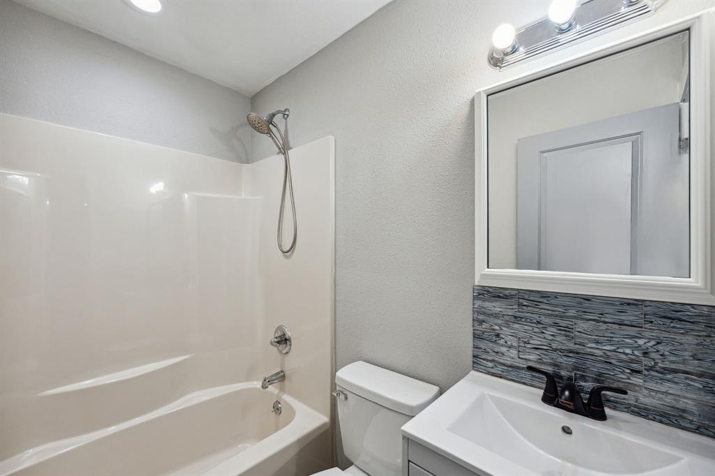 1605 South Walnut Street Sherman, TX 75090 - Photo 15 of 28 a bathroom with a sink a toilet and shower