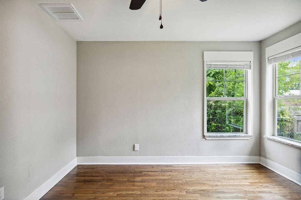 1605 South Walnut Street Sherman, TX 75090 - Photo 22 of 28 a view of an empty room with wooden floor and a window
