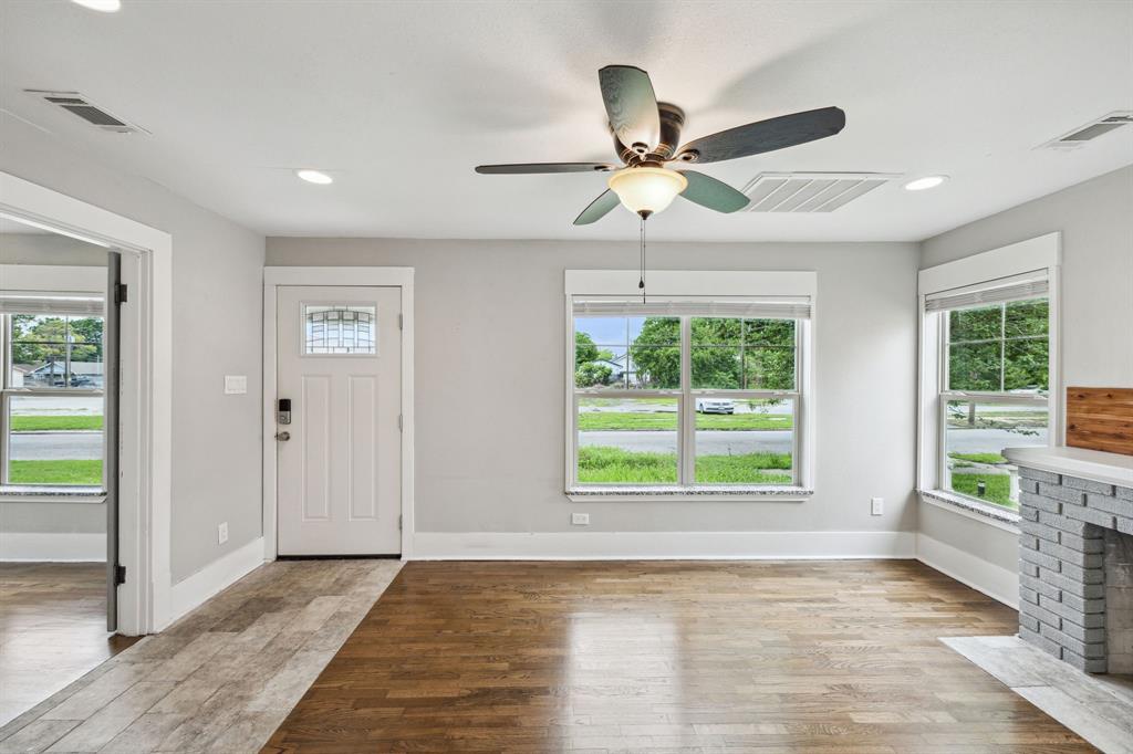 1605 South Walnut Street Sherman, TX 75090 - Photo 5 of 28 a view of an empty room with a window and wooden floor