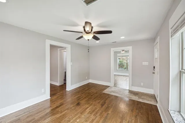 wooden floor in an empty room with a window