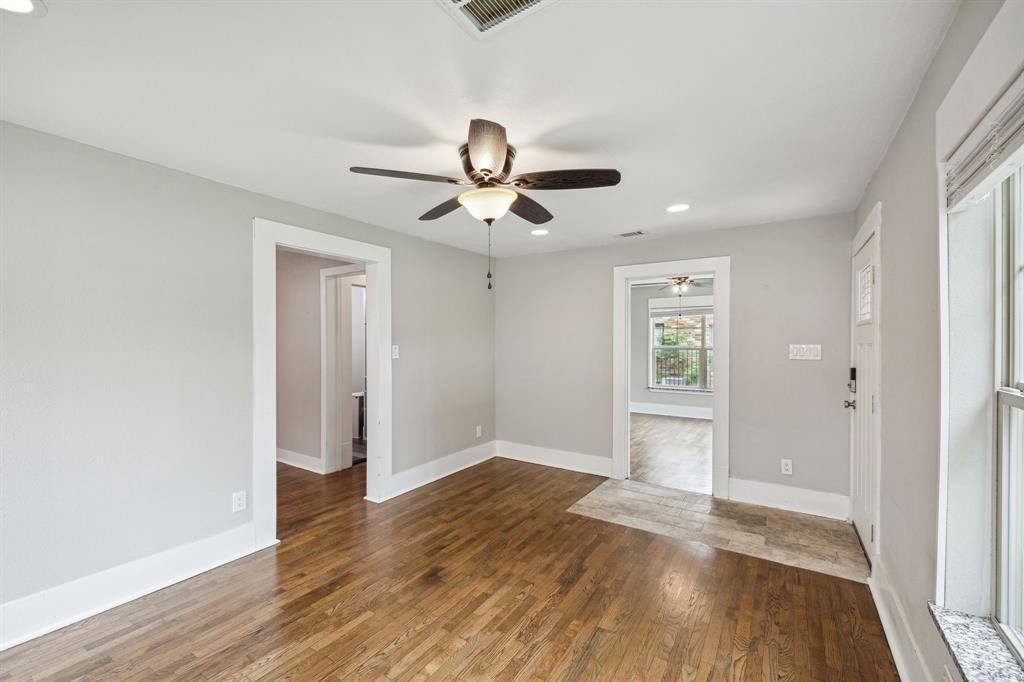 1605 South Walnut Street Sherman, TX 75090 - Photo 6 of 28 wooden floor in an empty room with a window