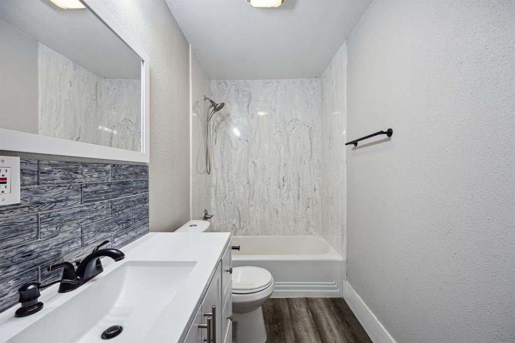 1605 South Walnut Street Sherman, TX 75090 - Photo 10 of 28 a bathroom with a sink a toilet and shower