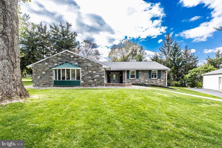 a front view of a house with a garden