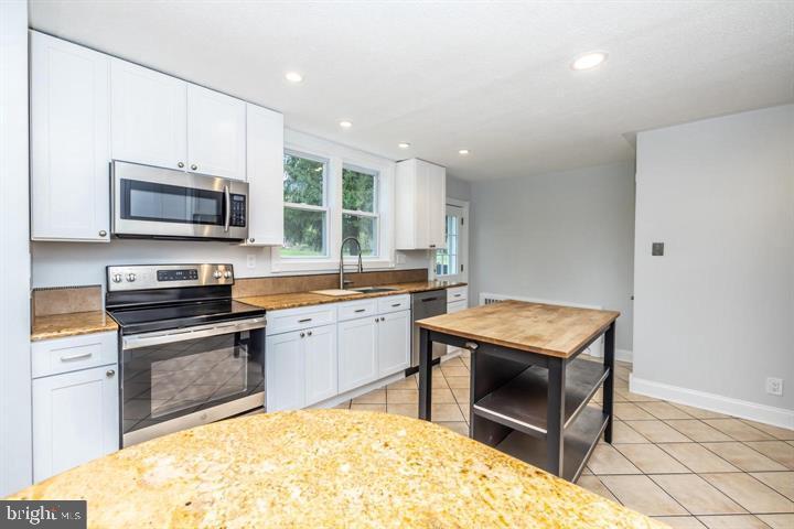 902 Croton Road Wayne, PA 19087 - Photo 13 of 37 a kitchen with a stove a sink and a microwave