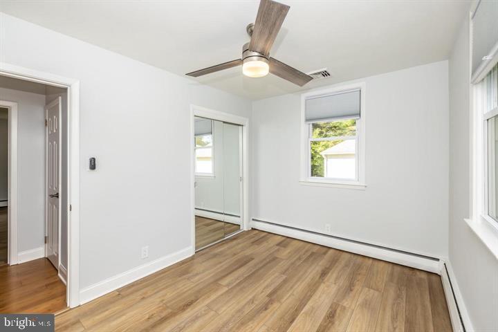 902 Croton Road Wayne, PA 19087 - Photo 20 of 37 an empty room with wooden floor fan and windows