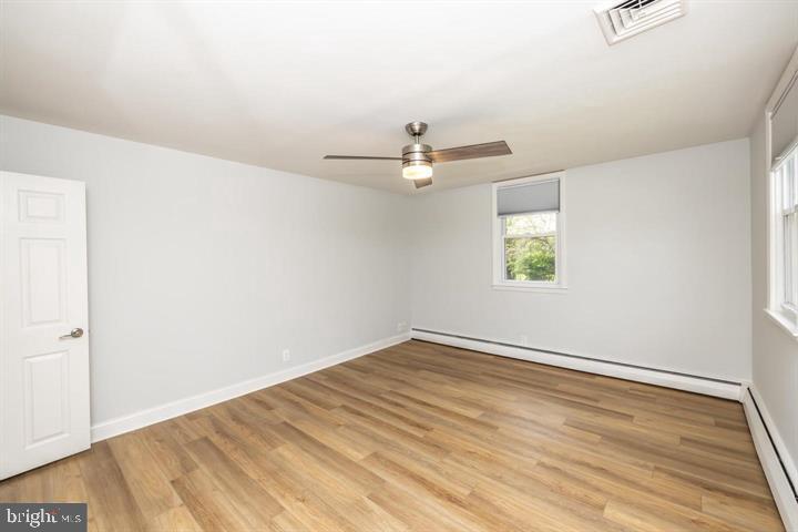 902 Croton Road Wayne, PA 19087 - Photo 24 of 37 an empty room with wooden floor ceiling fan and windows