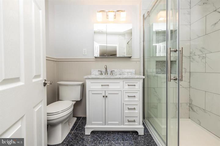 902 Croton Road Wayne, PA 19087 - Photo 32 of 37 a bathroom with a granite countertop toilet sink and a mirror
