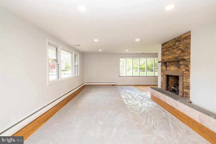 902 Croton Road Wayne, PA 19087 - Photo 6 of 37 an empty room with windows and fireplace