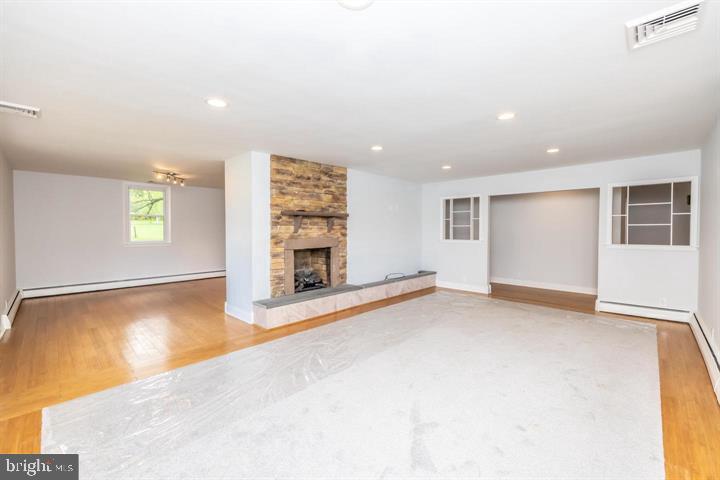902 Croton Road Wayne, PA 19087 - Photo 7 of 37 an empty room with windows and fireplace