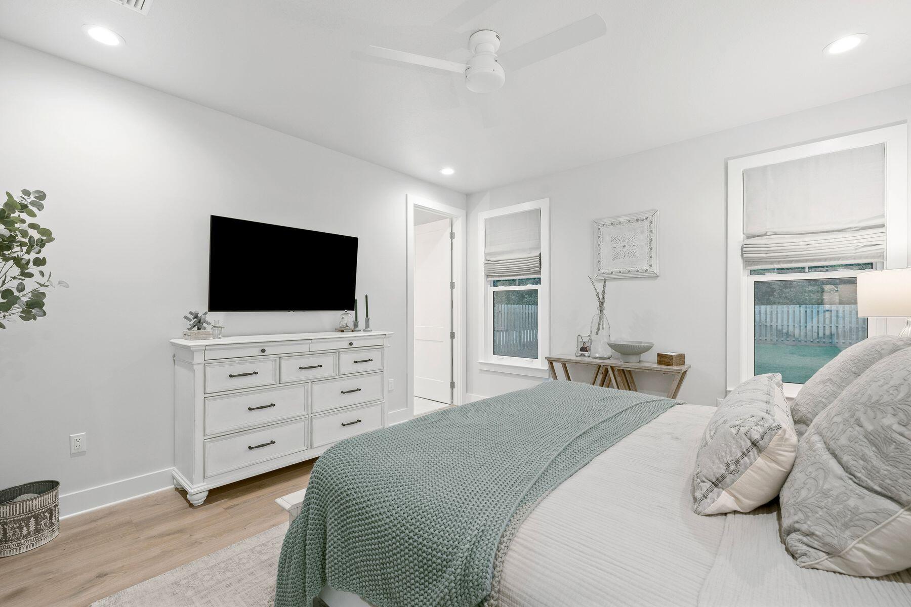 39 West Captain Fritz Way Freeport, FL 32439 - Photo 14 of 33 a bedroom with a bed and a flat screen tv