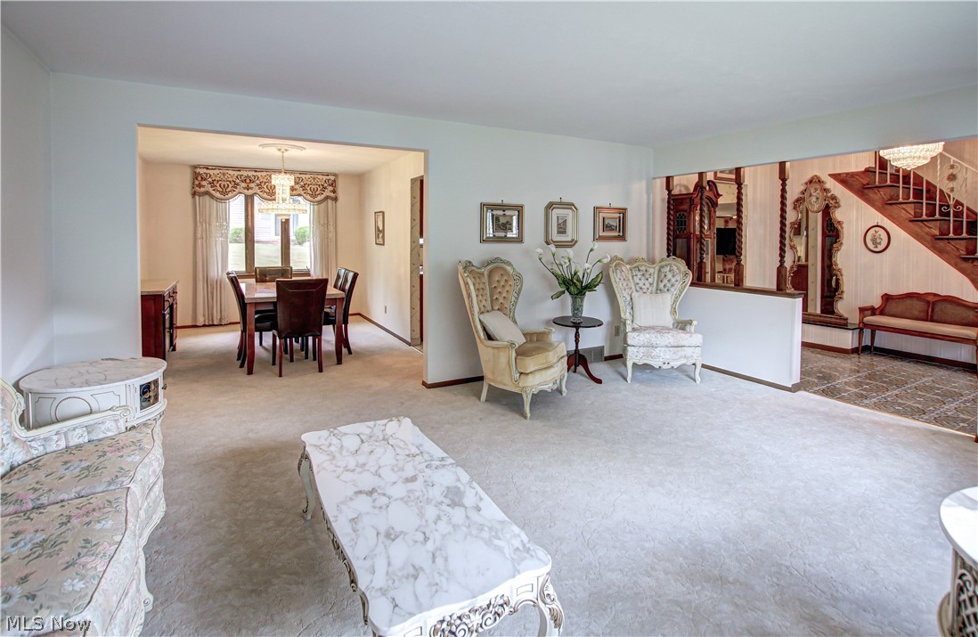 6013 Rousseau Drive Parma, OH 44129 - Photo 17 of 50 Carpeted living room with an inviting chandelier