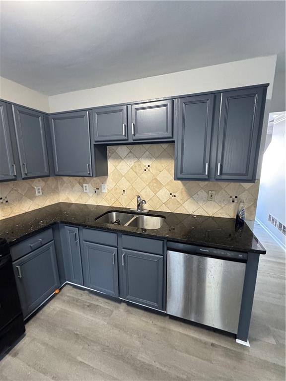 2441 Northmill Lane Decatur, GA 30035 - Photo 11 of 22 a kitchen with granite countertop wooden cabinets and stainless steel appliances