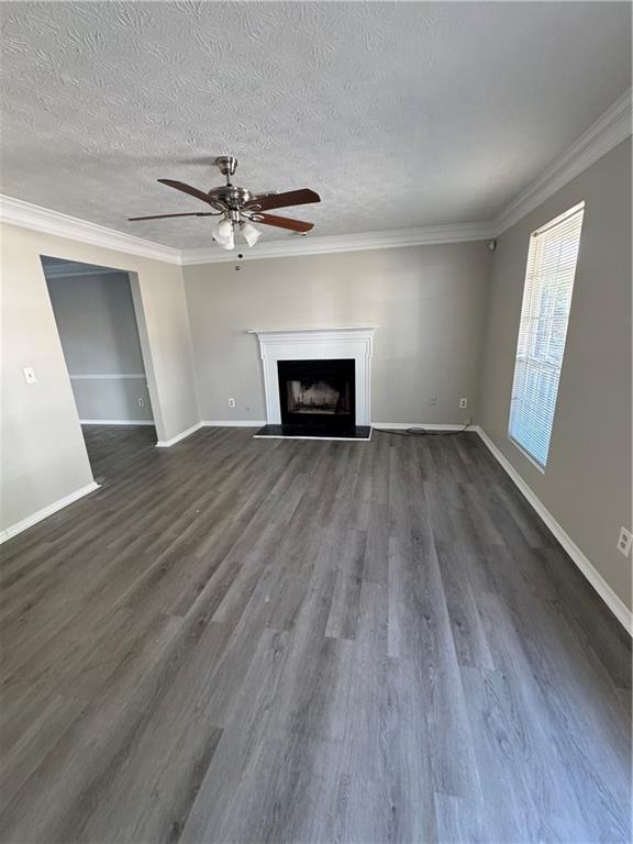 2441 Northmill Lane Decatur, GA 30035 - Photo 7 of 22 an empty room with wooden floor fireplace and windows