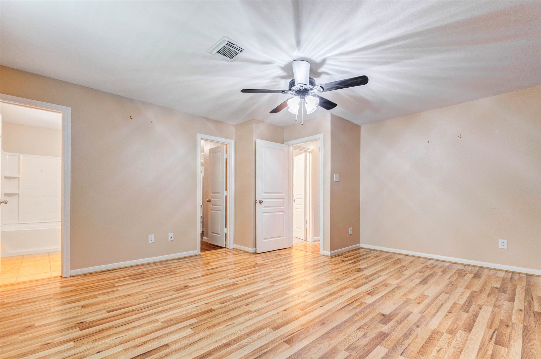 14522 Durham Chase Lane Houston, TX 77095 - Photo 27 of 40 a view of an empty room with wooden floor and a ceiling fan