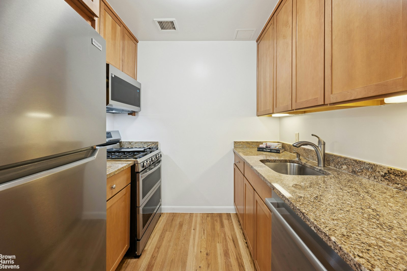 69 East 130th Street, Unit PHB Manhattan, NY 10037 - Photo 15 of 26 a kitchen with stainless steel appliances granite countertop a sink stove and refrigerator