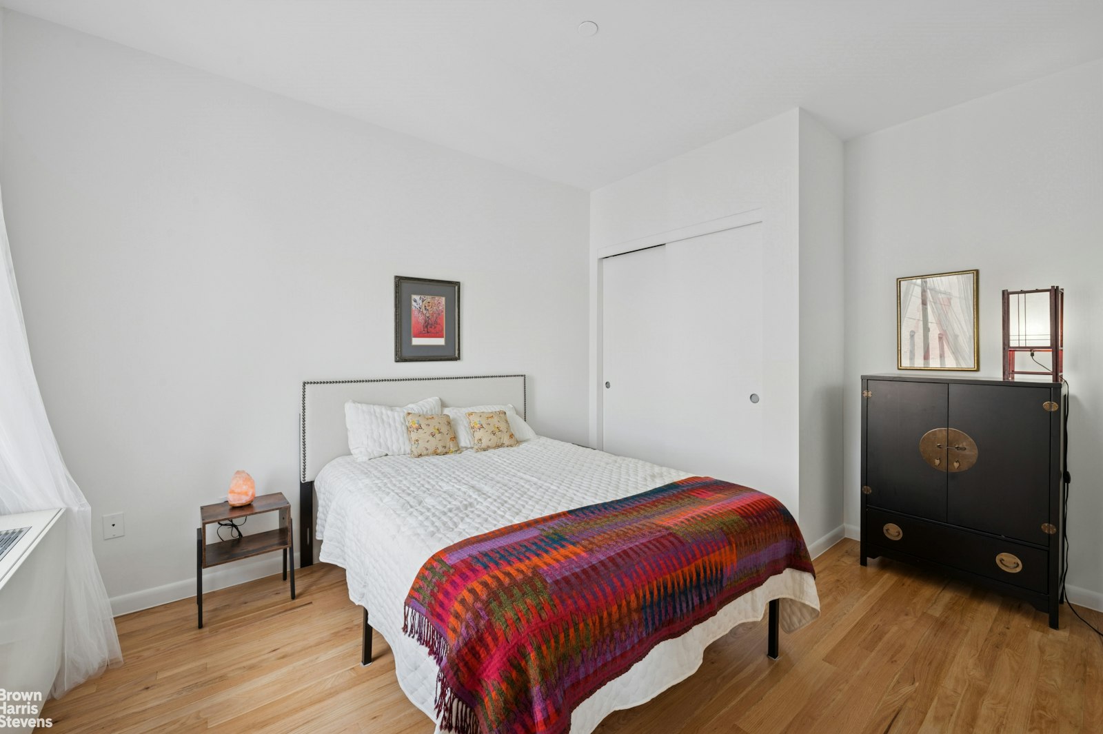 69 East 130th Street, Unit PHB Manhattan, NY 10037 - Photo 17 of 26 a bedroom with a bed and wooden floor