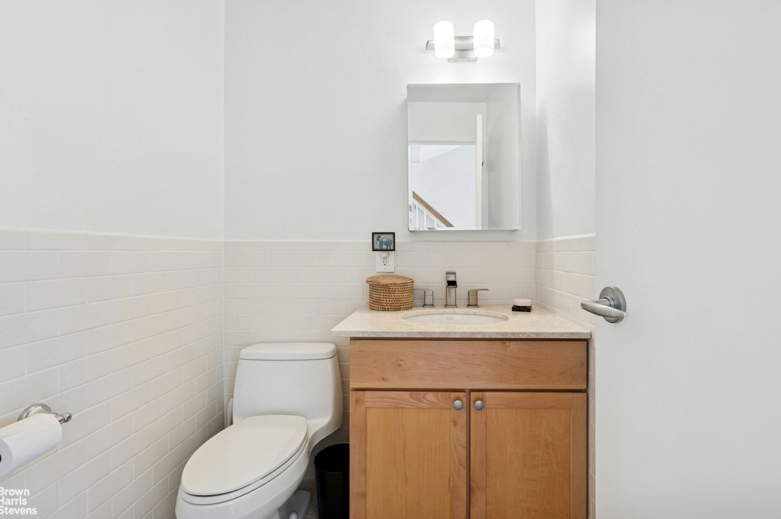 69 East 130th Street, Unit PHB Manhattan, NY 10037 - Photo 20 of 26 a bathroom with a toilet sink vanity and mirror