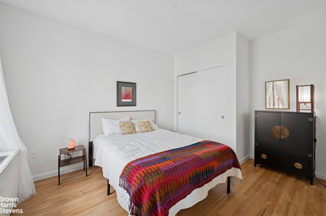 69 East 130th Street, Unit PHB Manhattan, NY 10037 - Photo 5 of 26 a bedroom with a bed and wooden floor