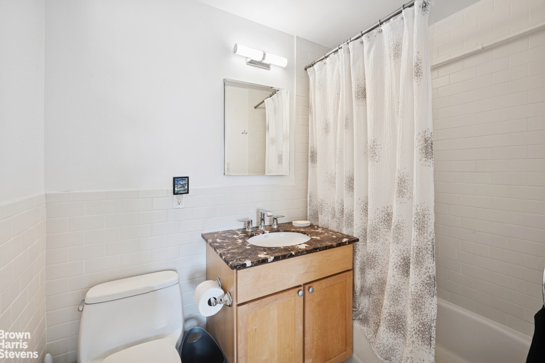 69 East 130th Street, Unit PHB Manhattan, NY 10037 - Photo 7 of 26 a bathroom with a granite countertop sink a toilet and shower