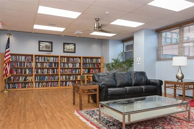 a view of a room with wooden floor and windows