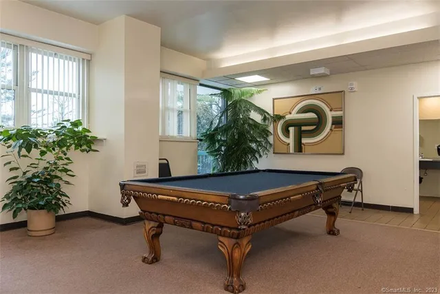 a room with a table chairs and entryway