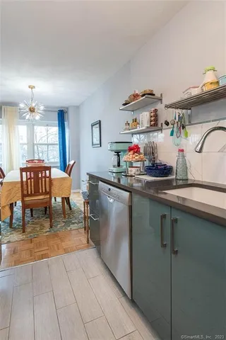 a kitchen with stainless steel appliances granite countertop a sink refrigerator and microwave