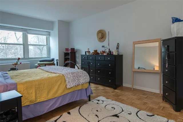 a bedroom with a bed and dresser