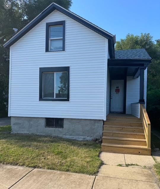 608 Front Street Aurora, IL 60505 - Photo 1 of 10 a front view of a house with garage