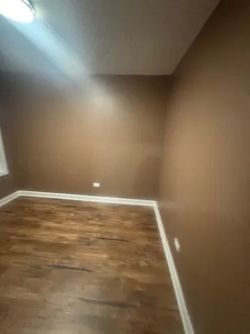 a view of room with wooden floor