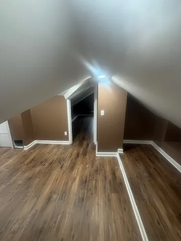 a view of room with window and wooden floor