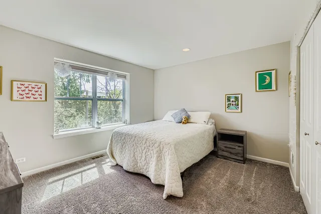 a bed sitting in a bedroom next to a window