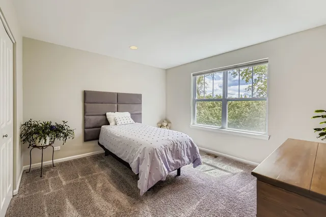 a bed sitting in a bedroom next to a window