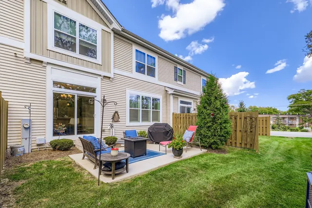 a view of a house with backyard sitting area and garden