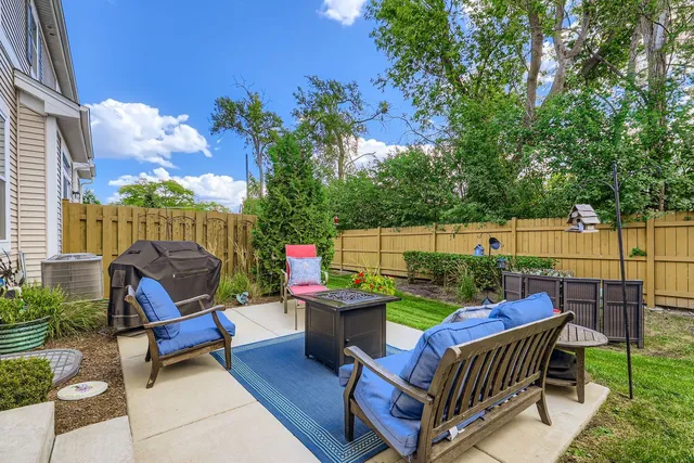 a view of a roof deck with furniture