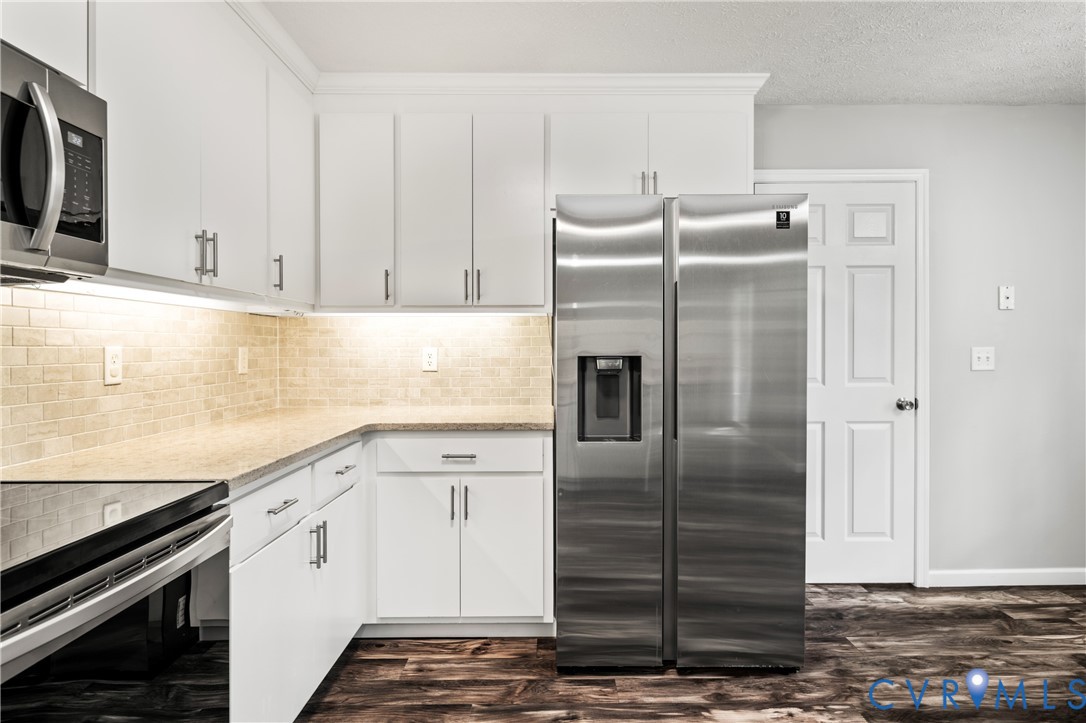 2099 Yacht Club Road Hayes, VA 23072 - Photo 19 of 42 a kitchen with a refrigerator sink and cabinets