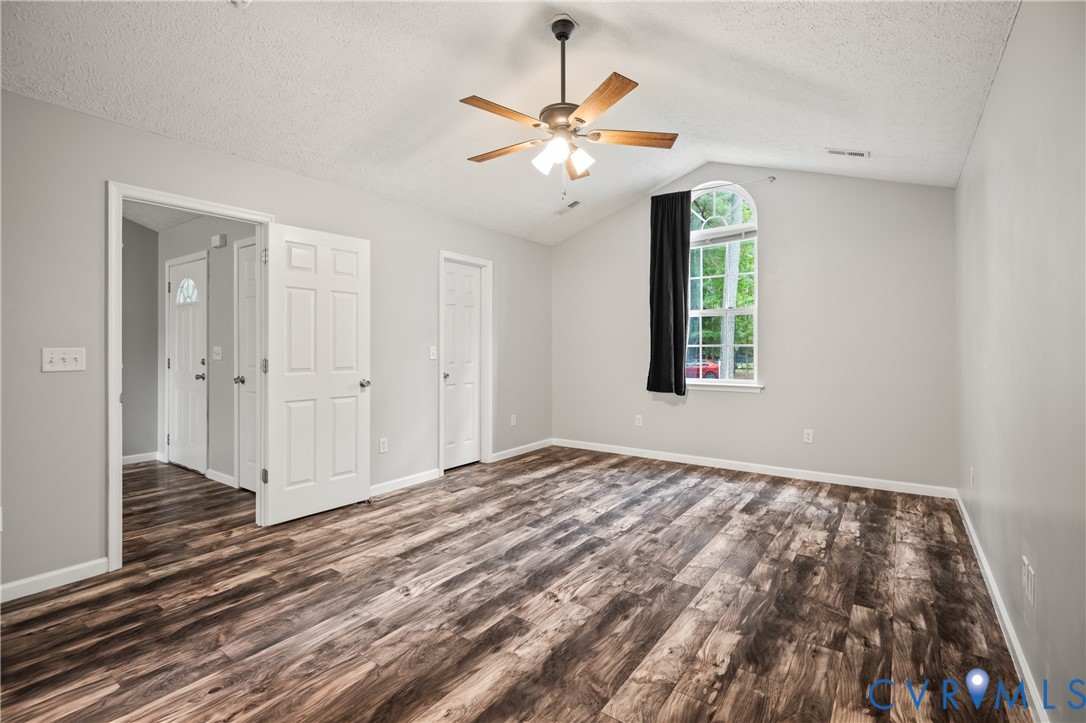 2099 Yacht Club Road Hayes, VA 23072 - Photo 23 of 42 a view of a room with wooden floor and a ceiling fan